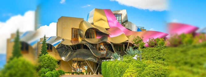 Trip Steiermark Reisetipps - Marqués de Riscal Design Hotel, Bilbao, Elciego, Spanien. Fantastisch galaktisch, unverkennbar ein Werk von Frank O. Gehry. Inmitten idyllischer Weinberge in der Rioja Region des Baskenlandes, bezaubert das schimmernde Bauobjekt mit einer Struktur bunter, edel glänzender verflochtener Metallbänder. Glanz im Baskenland - Es muss etwas ganz Besonderes sein. Emotional, zukunftsweisend, einzigartig. Denn in dieser Region, etwa 133 km südlich von Bilbao, sind Weingüter normalerweise nicht für die Öffentlichkeit zugänglich.